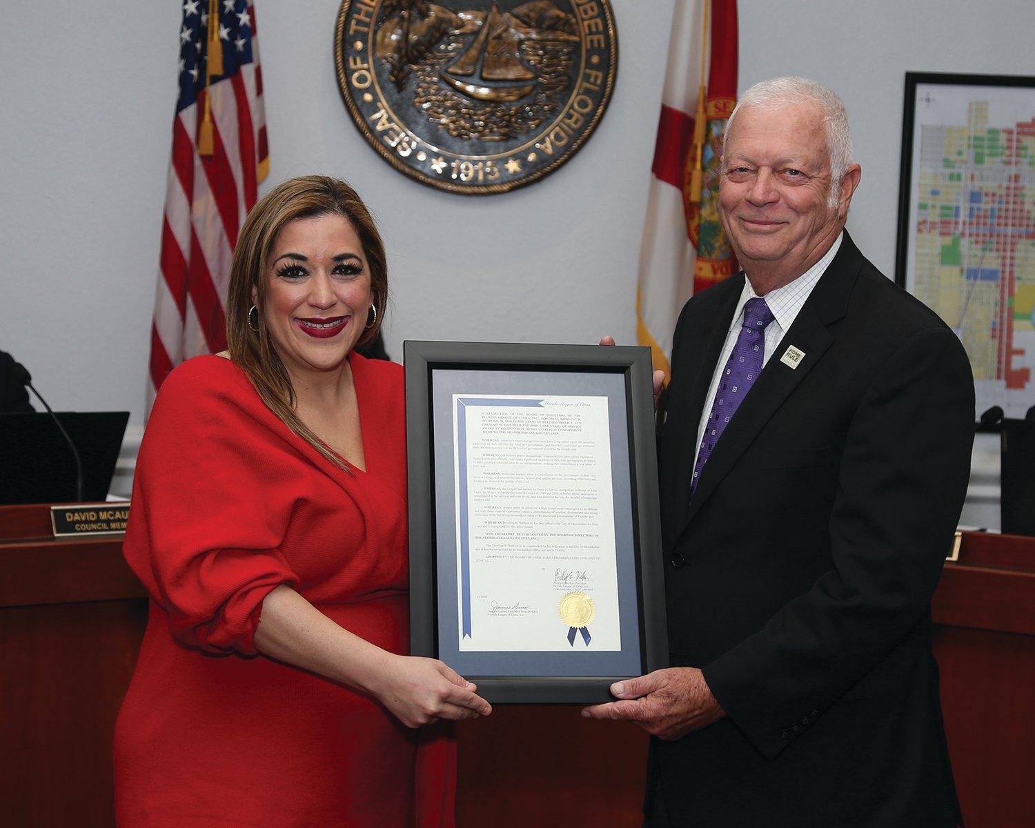 Jolien Caraballo, president of the Florida League of Cities presents Mayor Dowling Watford with a certificate celebrating 40 years of service to Okeechobee City